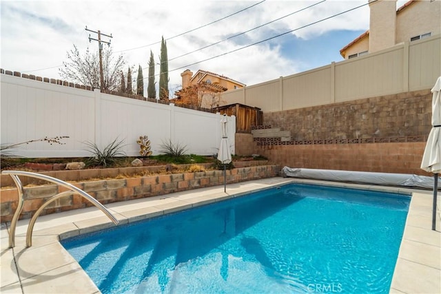 view of swimming pool featuring a fenced in pool and a fenced backyard