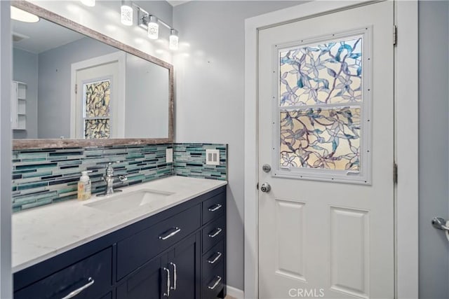 bathroom with plenty of natural light, tasteful backsplash, and vanity