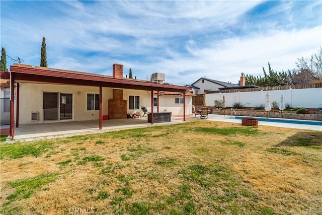 rear view of property with a yard, a patio, central AC, and fence