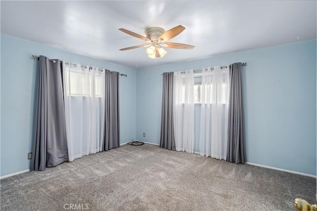 spare room featuring carpet floors and ceiling fan