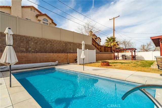 view of swimming pool with a patio, a fenced in pool, a yard, a fenced backyard, and a pergola