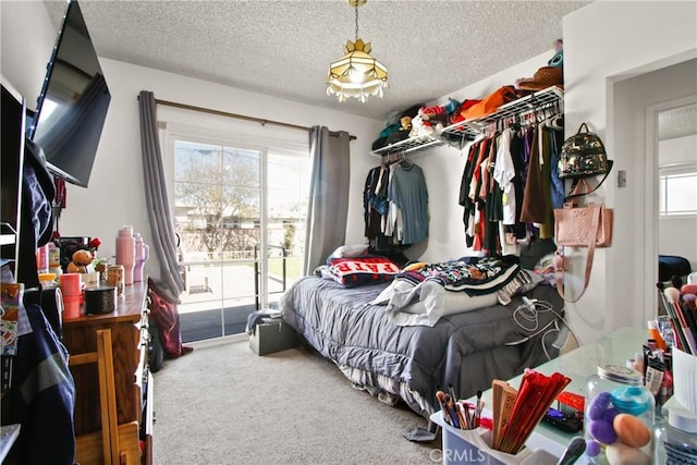 carpeted bedroom featuring multiple windows and a textured ceiling