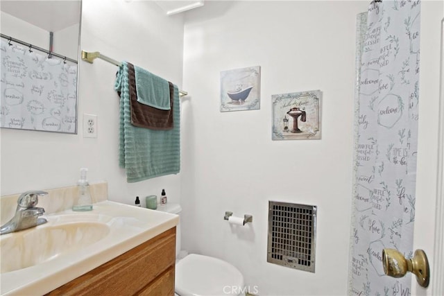 bathroom with visible vents, toilet, vanity, and a shower with curtain