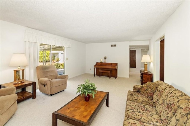 carpeted living area featuring visible vents and a textured ceiling