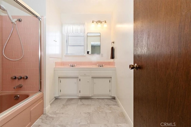 full bath with baseboards, double vanity, a sink, shower / washtub combination, and marble finish floor