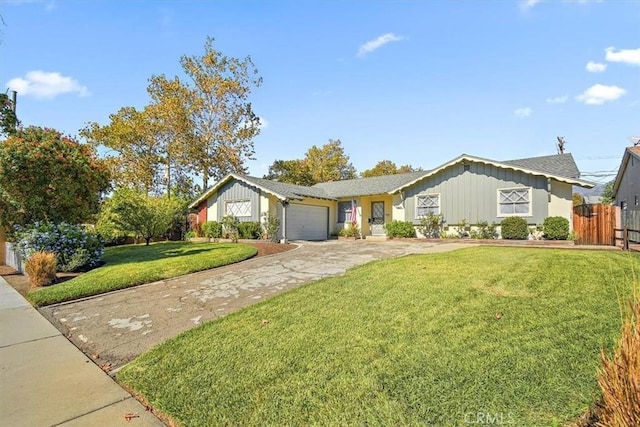 ranch-style house with driveway, an attached garage, a front yard, and fence