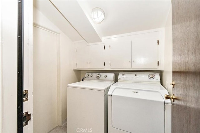 washroom featuring cabinet space and washing machine and dryer