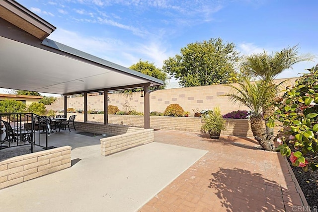 view of patio with outdoor dining space and a fenced backyard