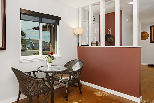 dining room featuring wood finished floors and baseboards