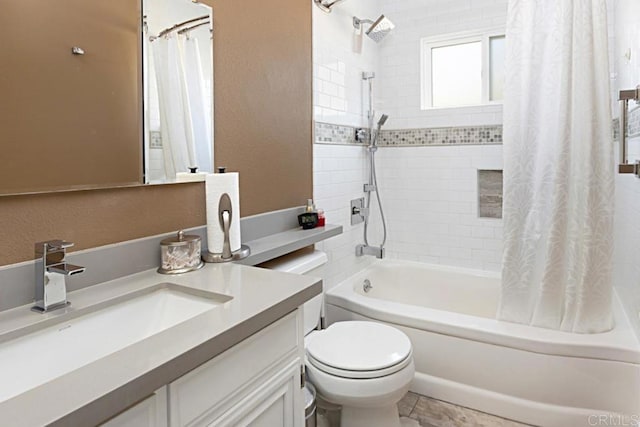 bathroom with vanity, toilet, a textured wall, and shower / bath combo