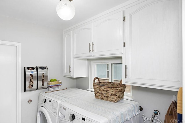 laundry area with cabinet space and separate washer and dryer