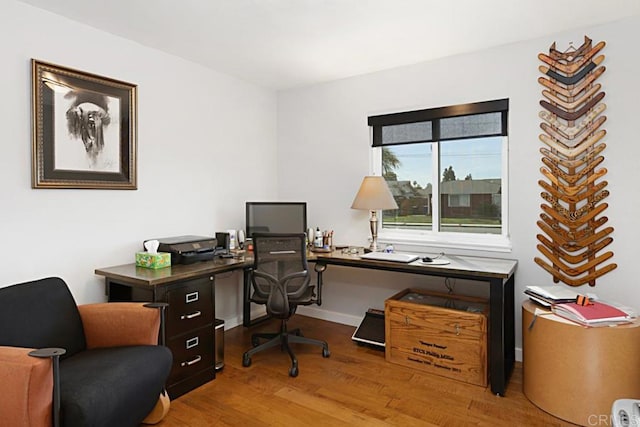 home office featuring baseboards and wood finished floors