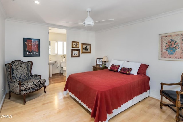 bedroom with crown molding, wood finished floors, ensuite bathroom, and ceiling fan