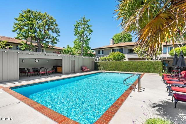 community pool featuring a patio and fence