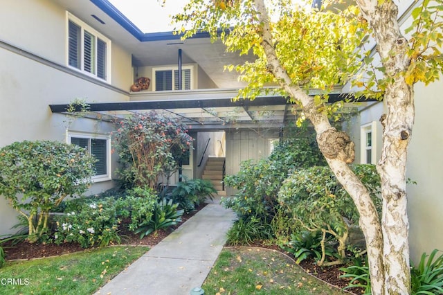 doorway to property featuring stucco siding