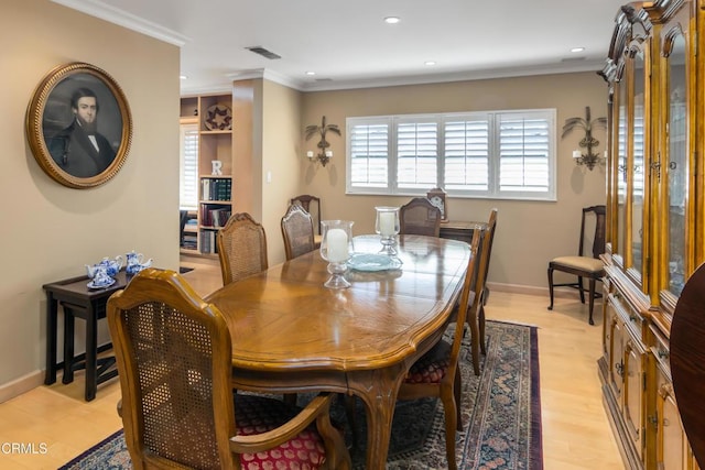 dining space with light wood finished floors, visible vents, crown molding, baseboards, and recessed lighting