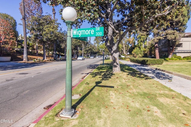 view of street featuring curbs, street lighting, and sidewalks