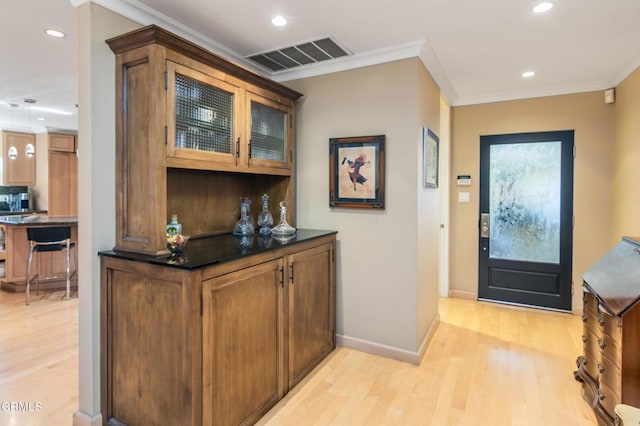 entryway with recessed lighting, visible vents, ornamental molding, and light wood-style flooring