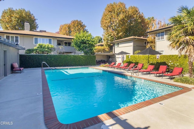 pool featuring a patio and fence