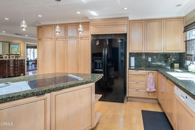 kitchen featuring black appliances, light brown cabinets, a sink, crown molding, and decorative backsplash