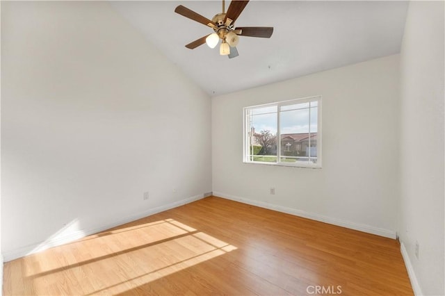 unfurnished room with baseboards, a ceiling fan, wood finished floors, and lofted ceiling