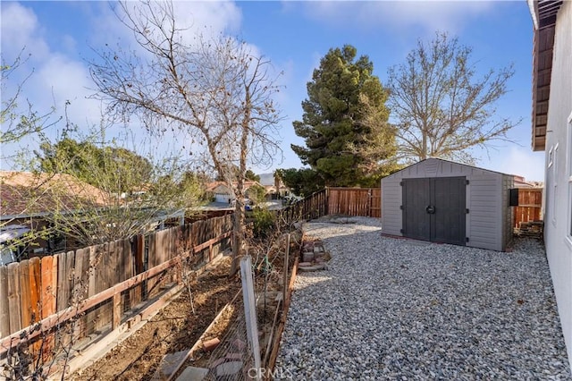 view of yard featuring an outbuilding, a shed, and a fenced backyard