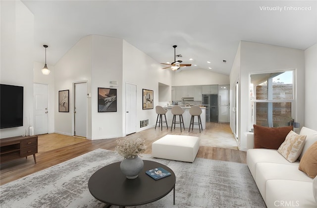living area with visible vents, recessed lighting, light wood-style floors, ceiling fan, and high vaulted ceiling