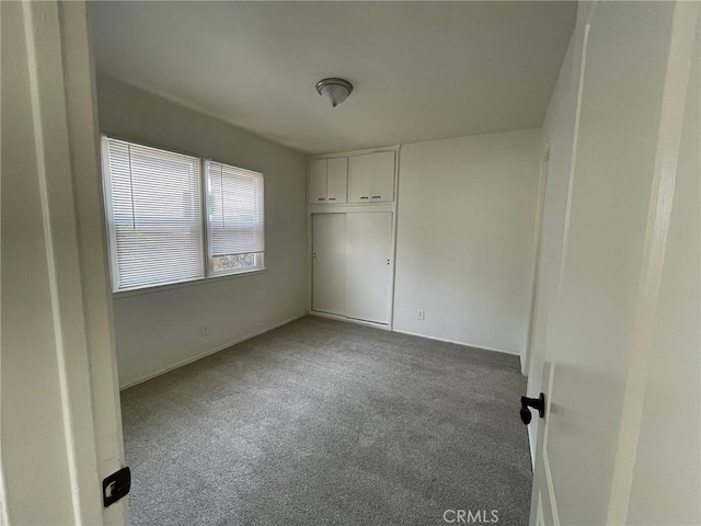 unfurnished bedroom with carpet flooring