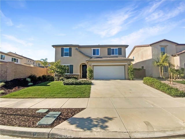 traditional-style house featuring a front yard, fence, an attached garage, stucco siding, and concrete driveway