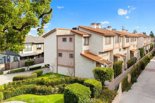 view of building exterior with a residential view and fence