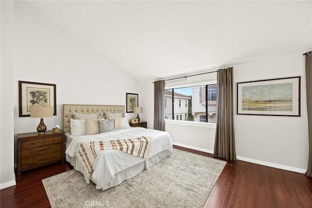 bedroom featuring baseboards, a textured ceiling, dark wood finished floors, and vaulted ceiling