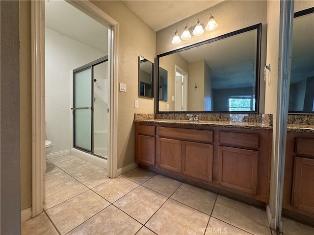 full bath featuring toilet, a stall shower, a textured wall, tile patterned floors, and vanity