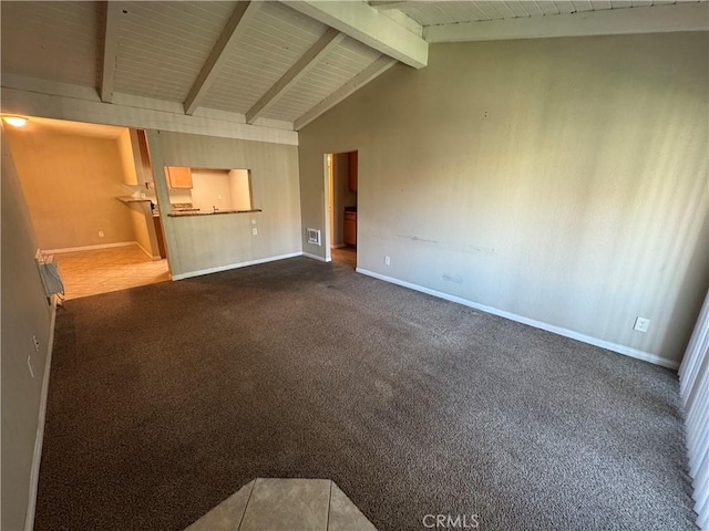 unfurnished living room featuring dark colored carpet, baseboards, and vaulted ceiling with beams