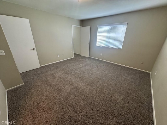 unfurnished bedroom with baseboards and carpet