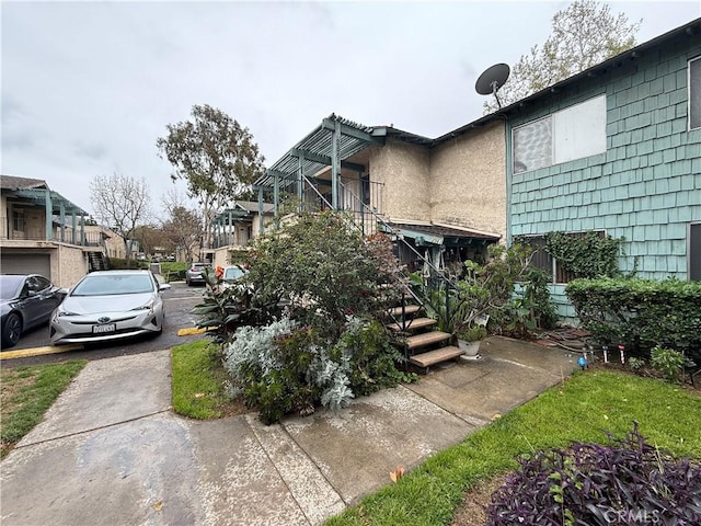 view of side of home with a pergola