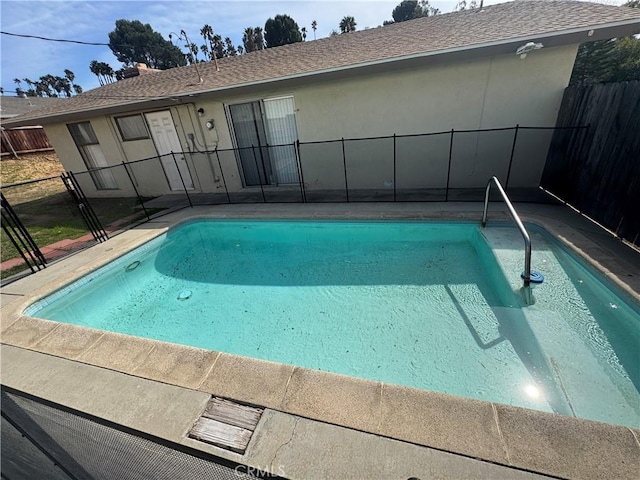 view of pool with a fenced in pool and fence