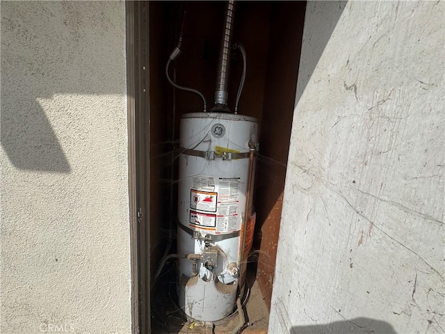 utility room featuring water heater