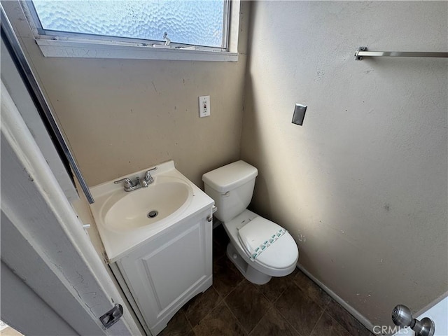 bathroom featuring toilet and vanity