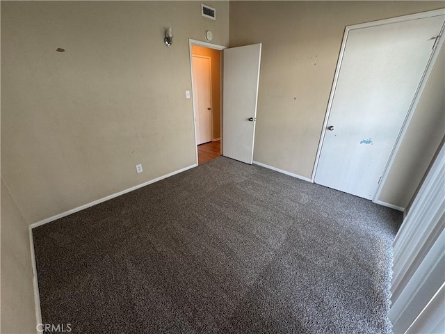 unfurnished bedroom featuring visible vents, baseboards, and carpet