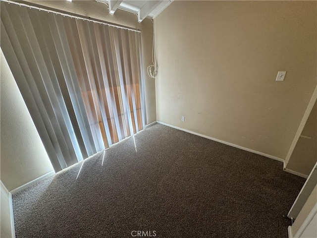 unfurnished room featuring carpet flooring and baseboards