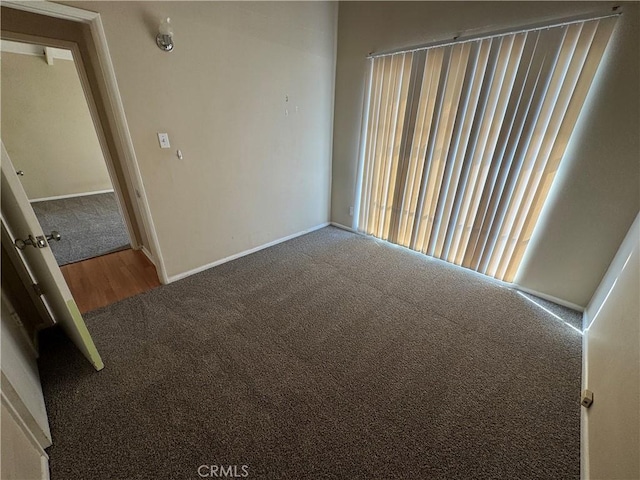 empty room with carpet flooring and baseboards