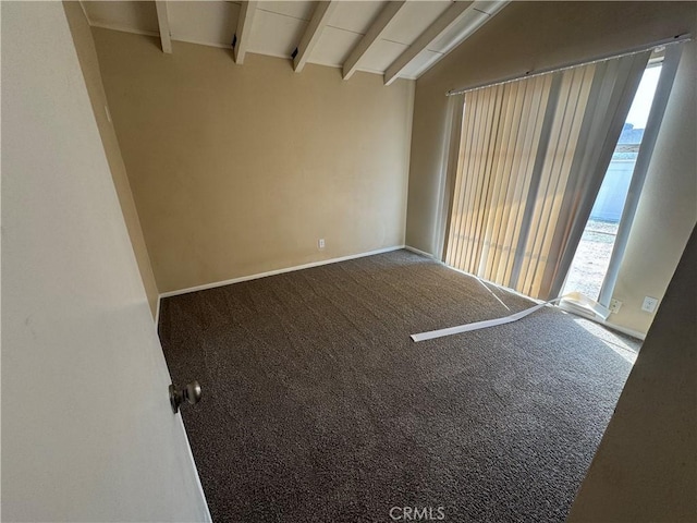 carpeted empty room with lofted ceiling with beams and baseboards