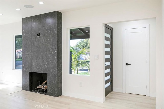 interior space with recessed lighting, a healthy amount of sunlight, and wood finished floors