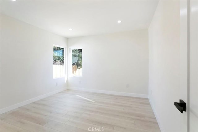 spare room with recessed lighting, light wood-style flooring, and baseboards