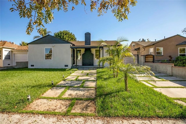 ranch-style home featuring crawl space, stucco siding, a chimney, and a front lawn