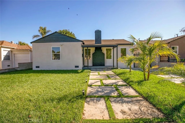 view of front facade featuring a front yard, stucco siding, a chimney, and crawl space