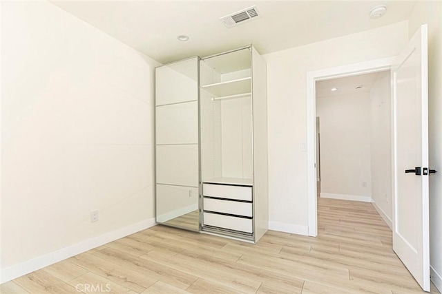 unfurnished bedroom featuring recessed lighting, visible vents, baseboards, and light wood finished floors