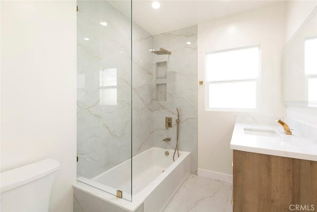 bathroom featuring vanity, baseboards, toilet, marble finish floor, and shower / bathtub combination