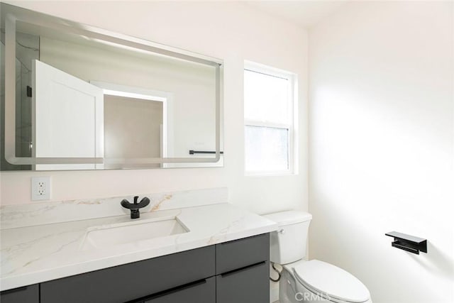 bathroom featuring toilet and vanity