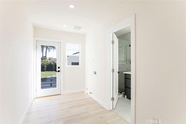 doorway to outside featuring recessed lighting, visible vents, light wood finished floors, and baseboards